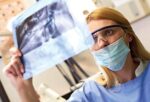493ss_thinkstock_rf_dentist_examining_xray 