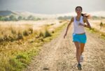 getty_rm_photo_of_woman_running_on_country_road 